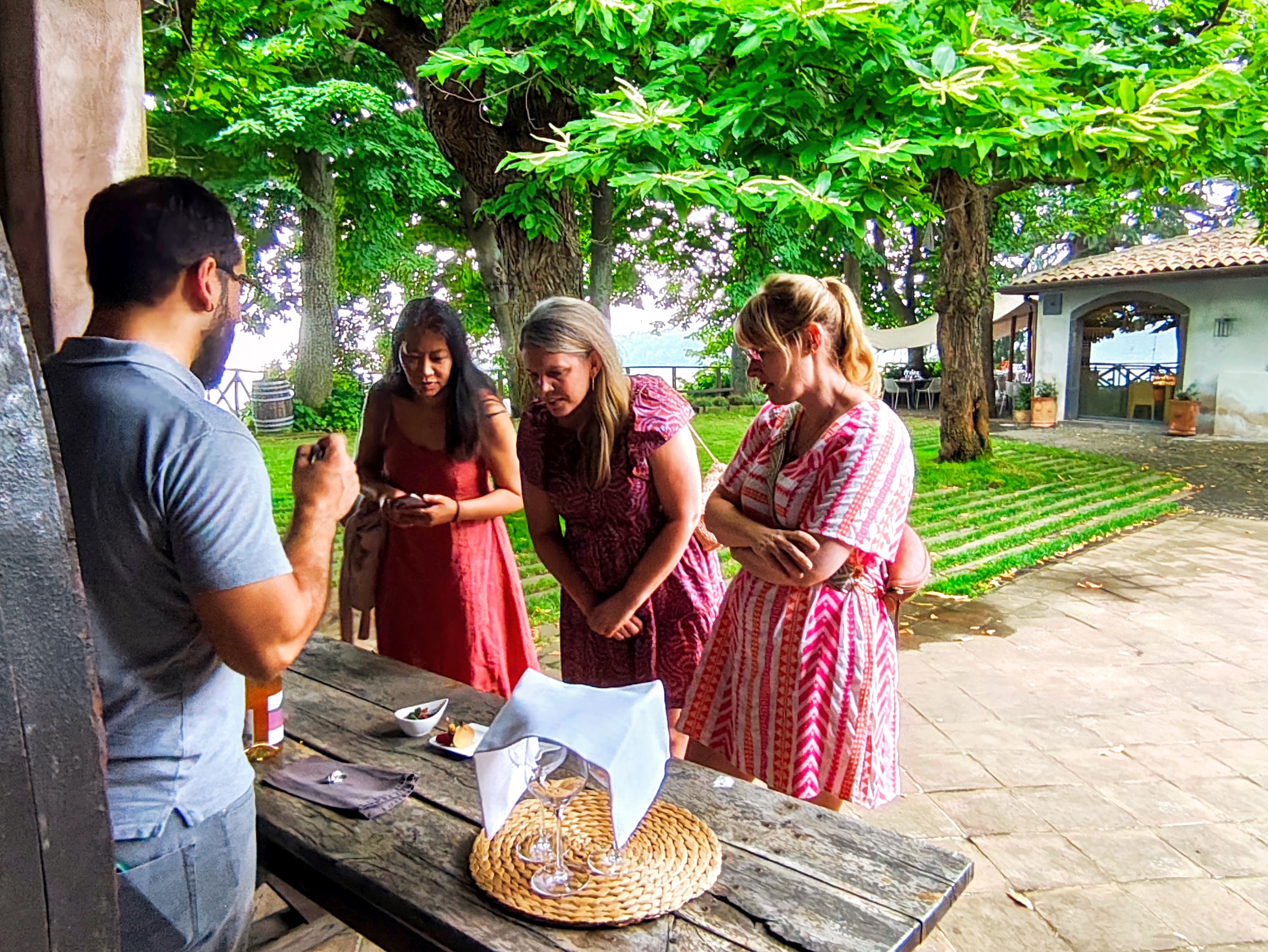 Wine tasting experience during a Sicily shore excursion from Messina Port with cruise passengers enjoying local Etna wine and food in a traditional countryside winery.